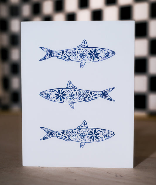 Card with blue fish illustrations on a checkered background
