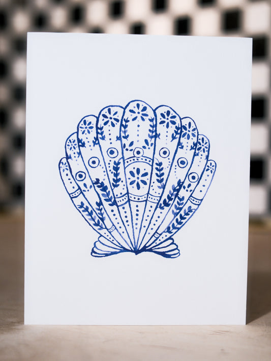 Card with a blue decorative shell design on a white background