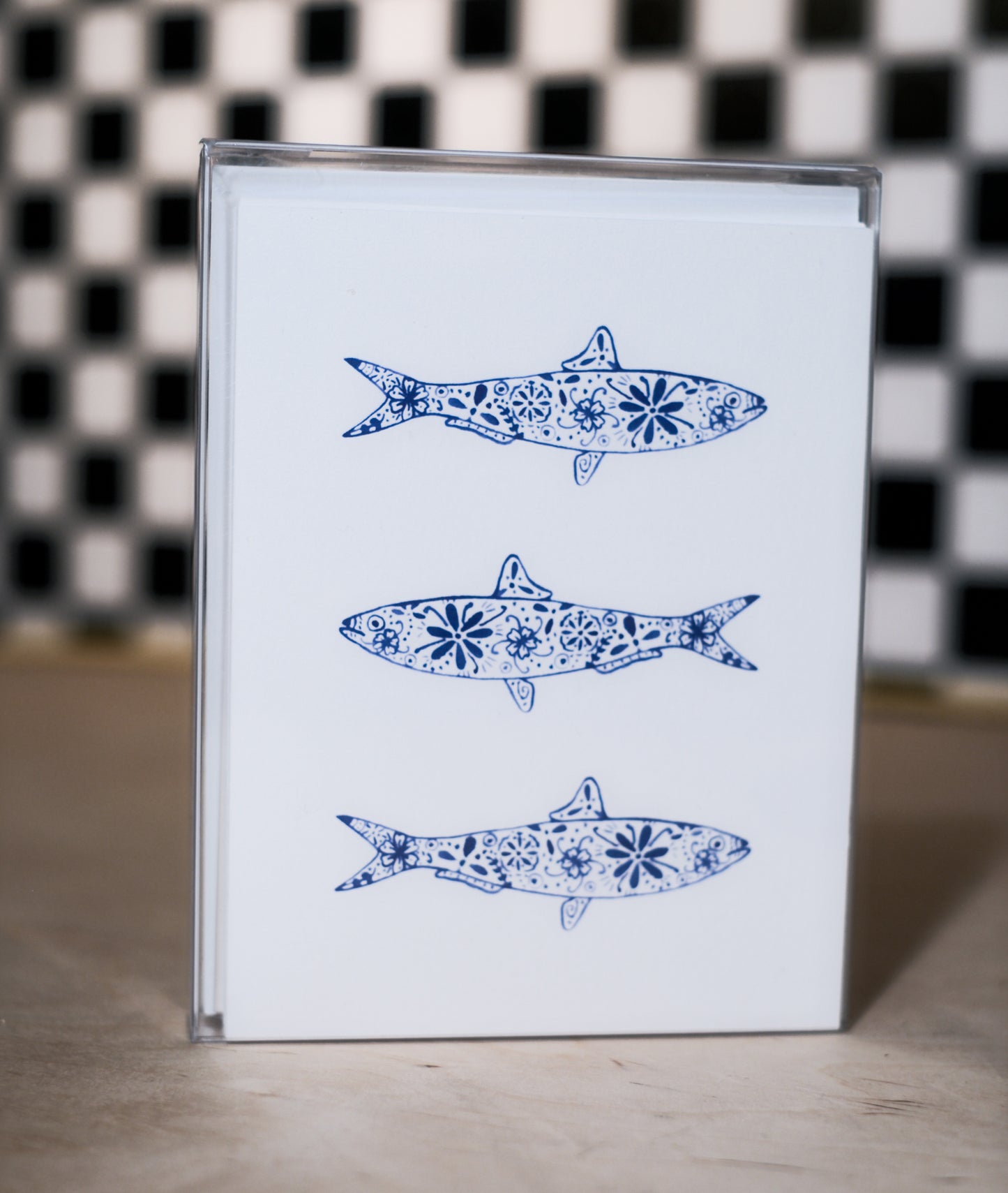 greeting card pack with blue fish illustrations on a checkered background