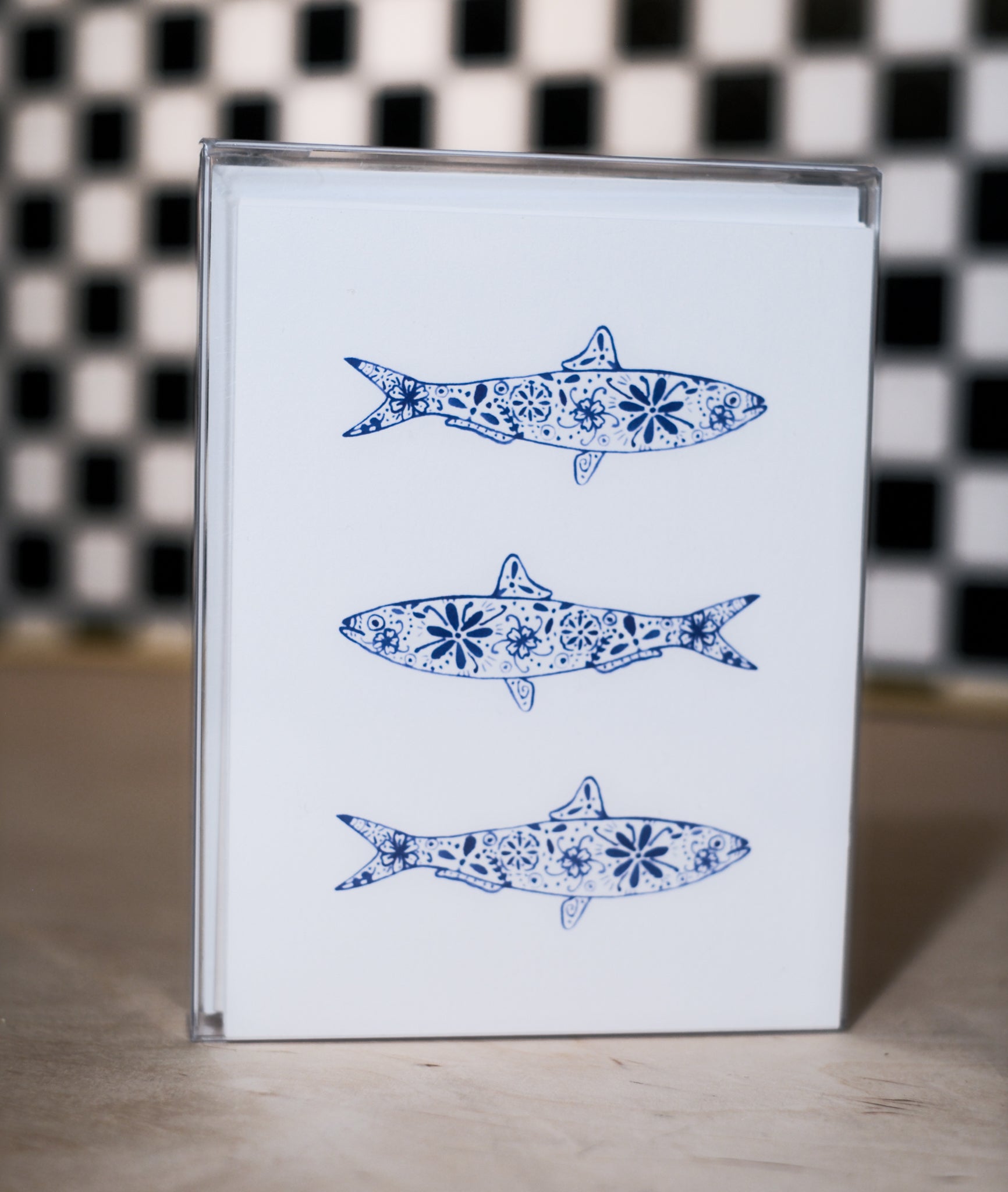 greeting card pack with blue fish illustrations on a checkered background