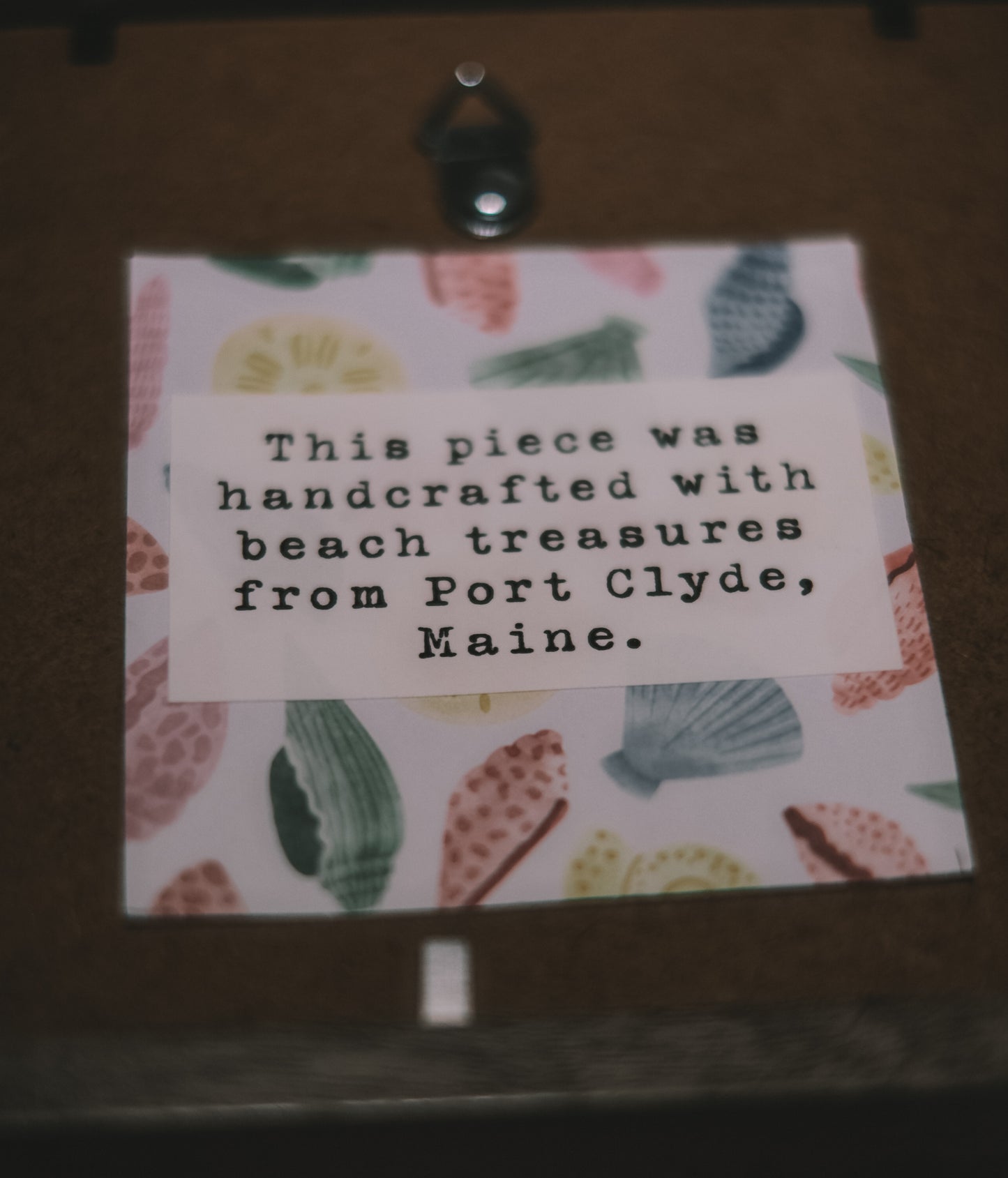 Card with beach-themed design and text on a wooden surface