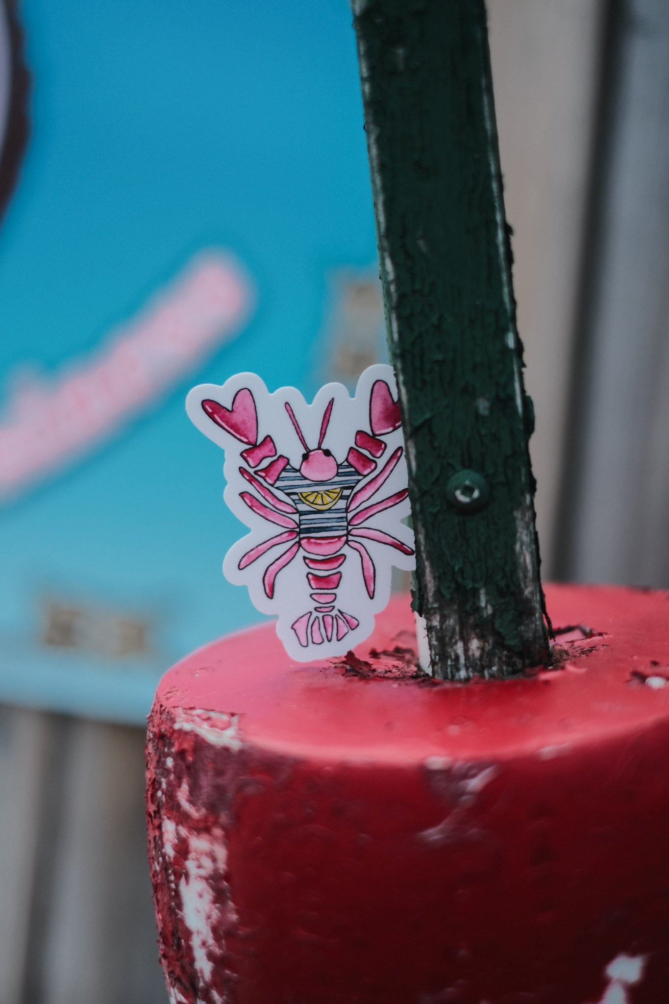 Close-up of a red lobster sticker on top of red buoy.