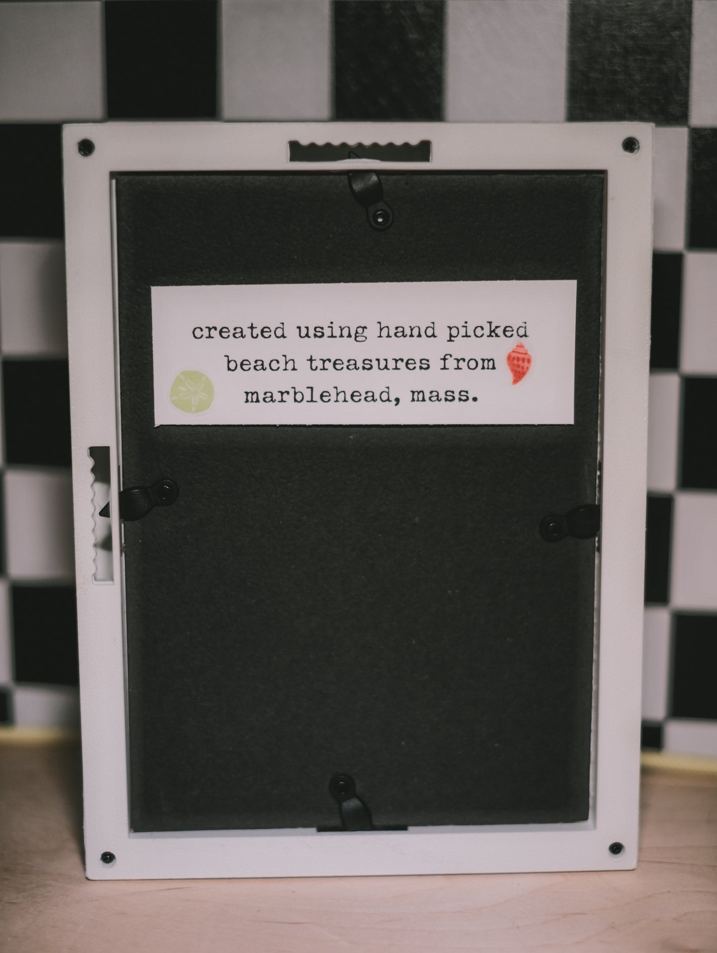 Black frame with a label on a checkered floor