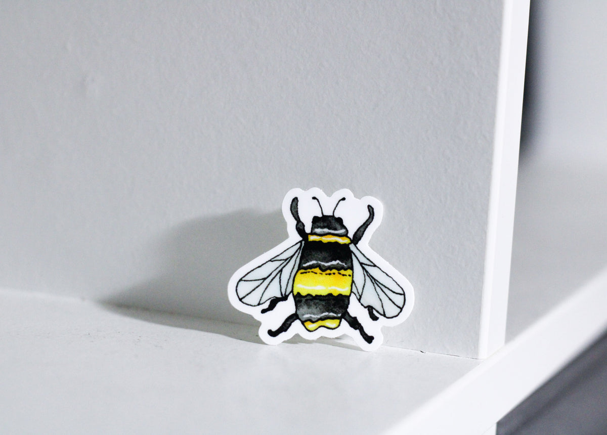 Photo of a watercolor black and yellow bee set on a white background.