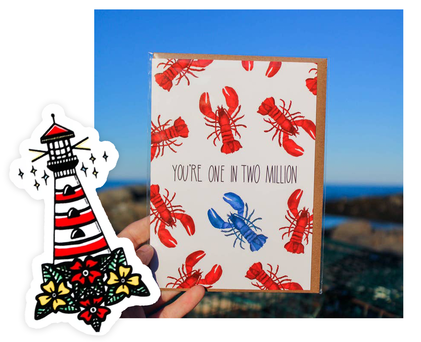 A hand holds a greeting card featuring multiple red lobsters and one blue lobster, with the text Youre one in two million. Beside it is a sticker illustration of a red and white striped lighthouse with flowers at the base, set against a clear blue sky.
