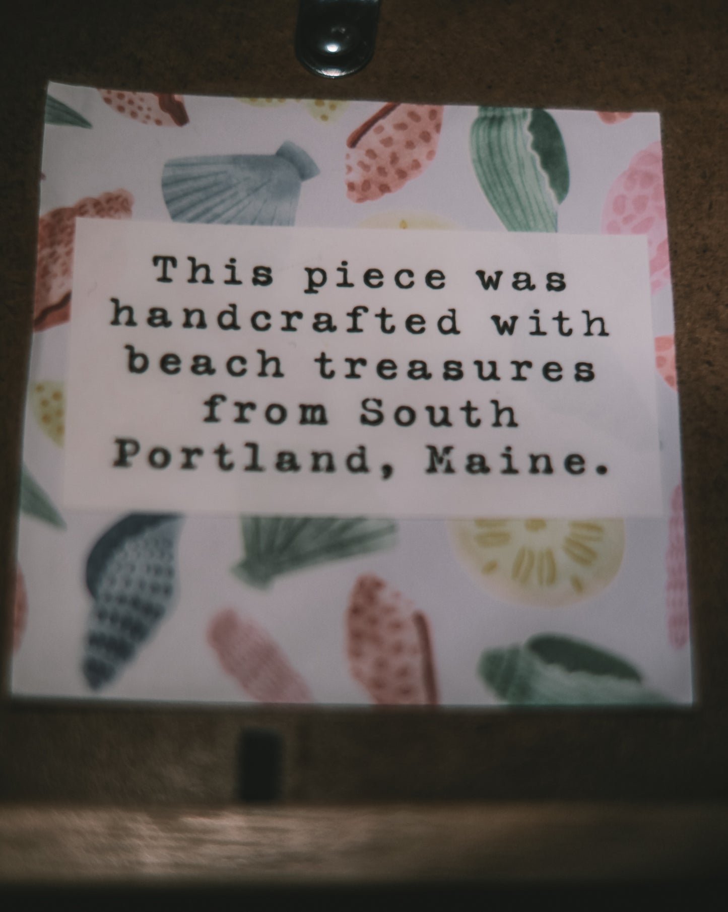 Note with text about beach treasures from South Portland, Maine on a decorative background