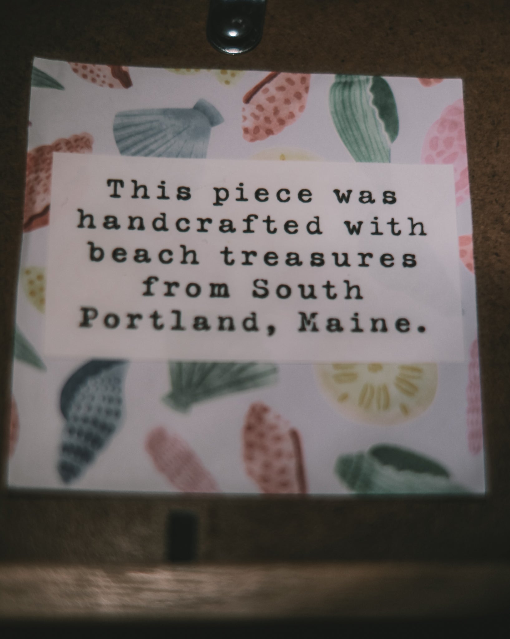 Note with text about beach treasures from South Portland, Maine on a decorative background