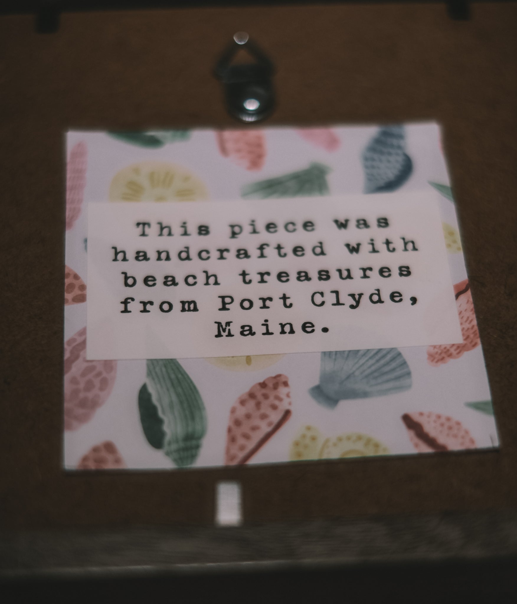 Card with beach-themed design and text on a wooden surface