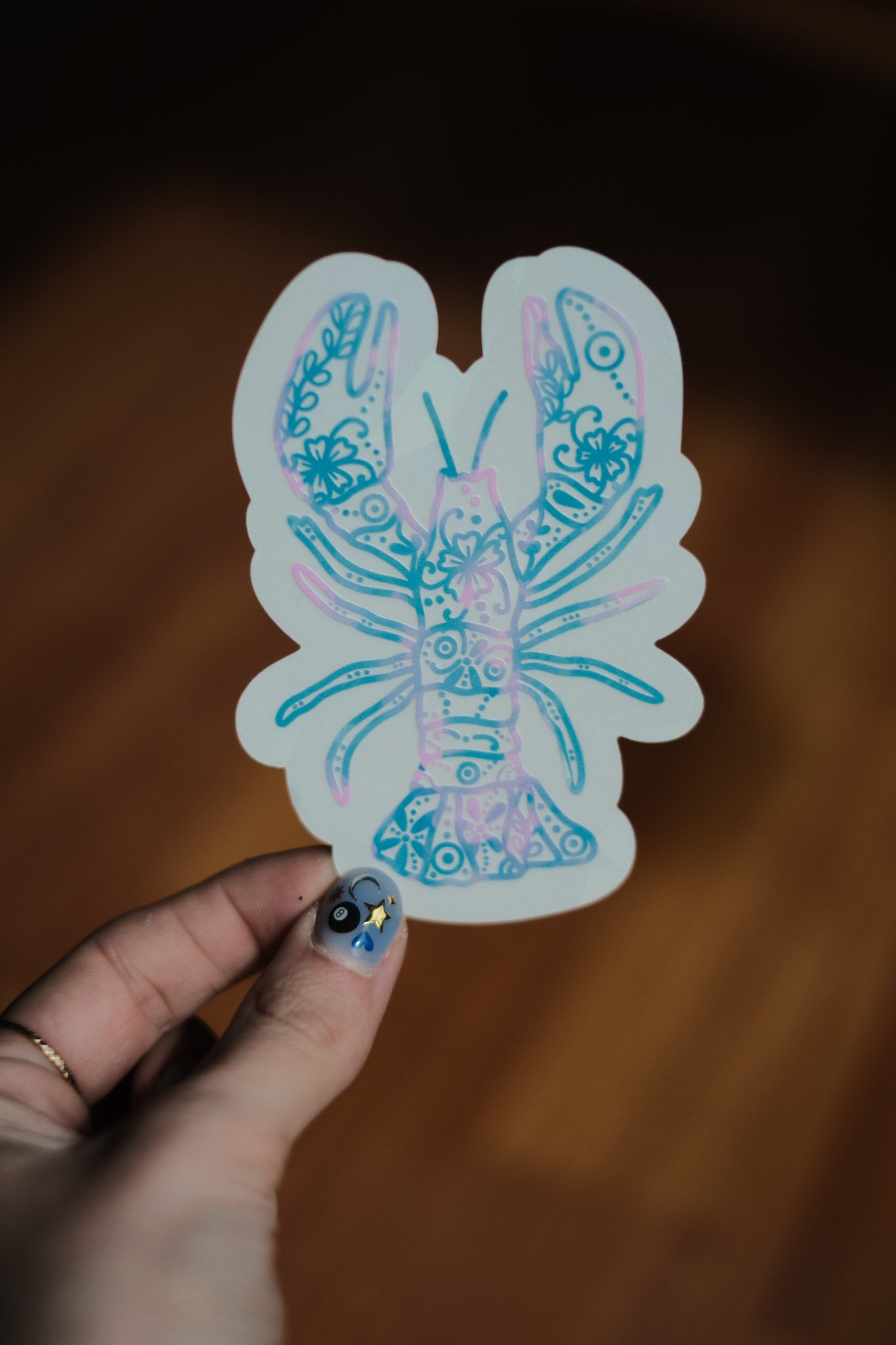 pink and blue lobster sun catcher decal with flower pattern.