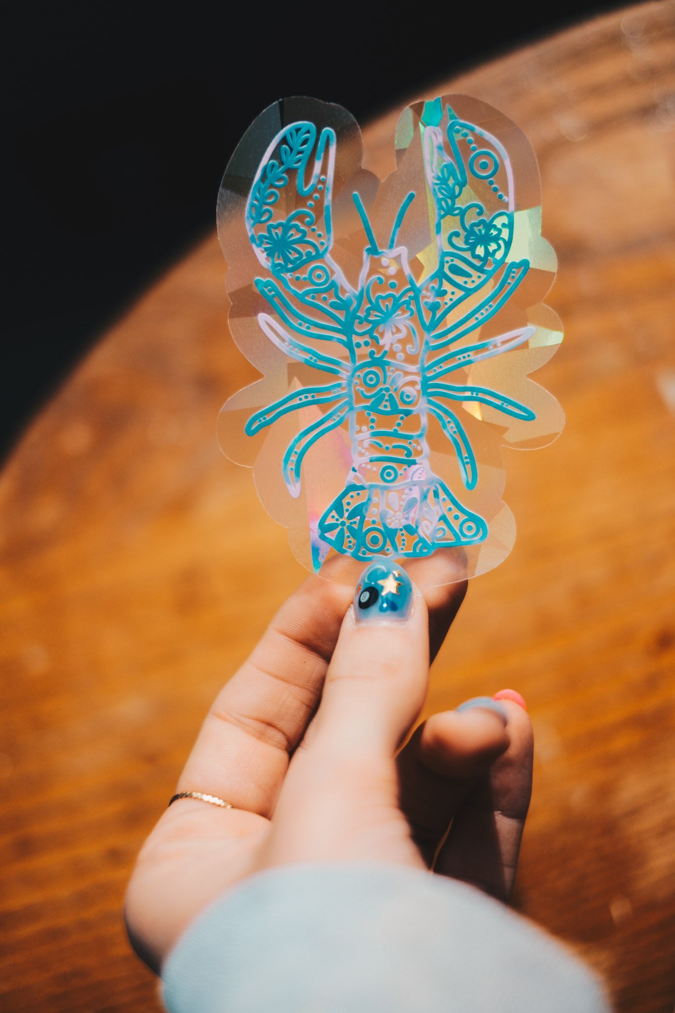 pink and blue lobster sun catcher decal with flower pattern.