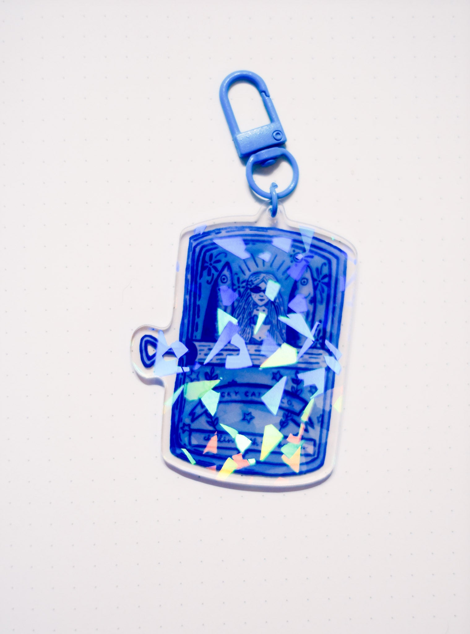 Blue keychain with a transparent design on a white background
